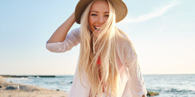 Girl with blond hair at the beach on a summer day